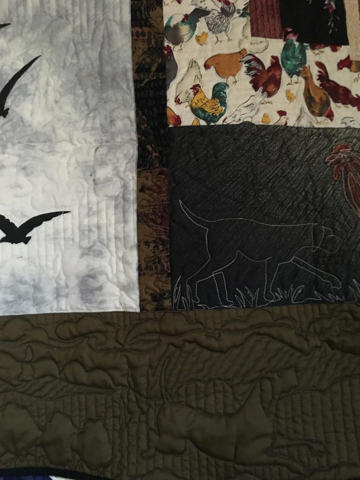 Gallery 13 - Detail of quilting combining laura's drawings - recorded-digitized-requilted with freehand quilting combined. This is the mainstay of Laura's work for clients. Hounddogs in the Hills quilted corner of quilt