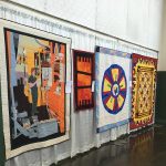Gallery 8 - pressman in a quilt, geometric patchworks with details in continuous quilting llnes