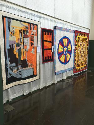 Gallery 8 - pressman in a quilt, geometric patchworks with details in continuous quilting llnes